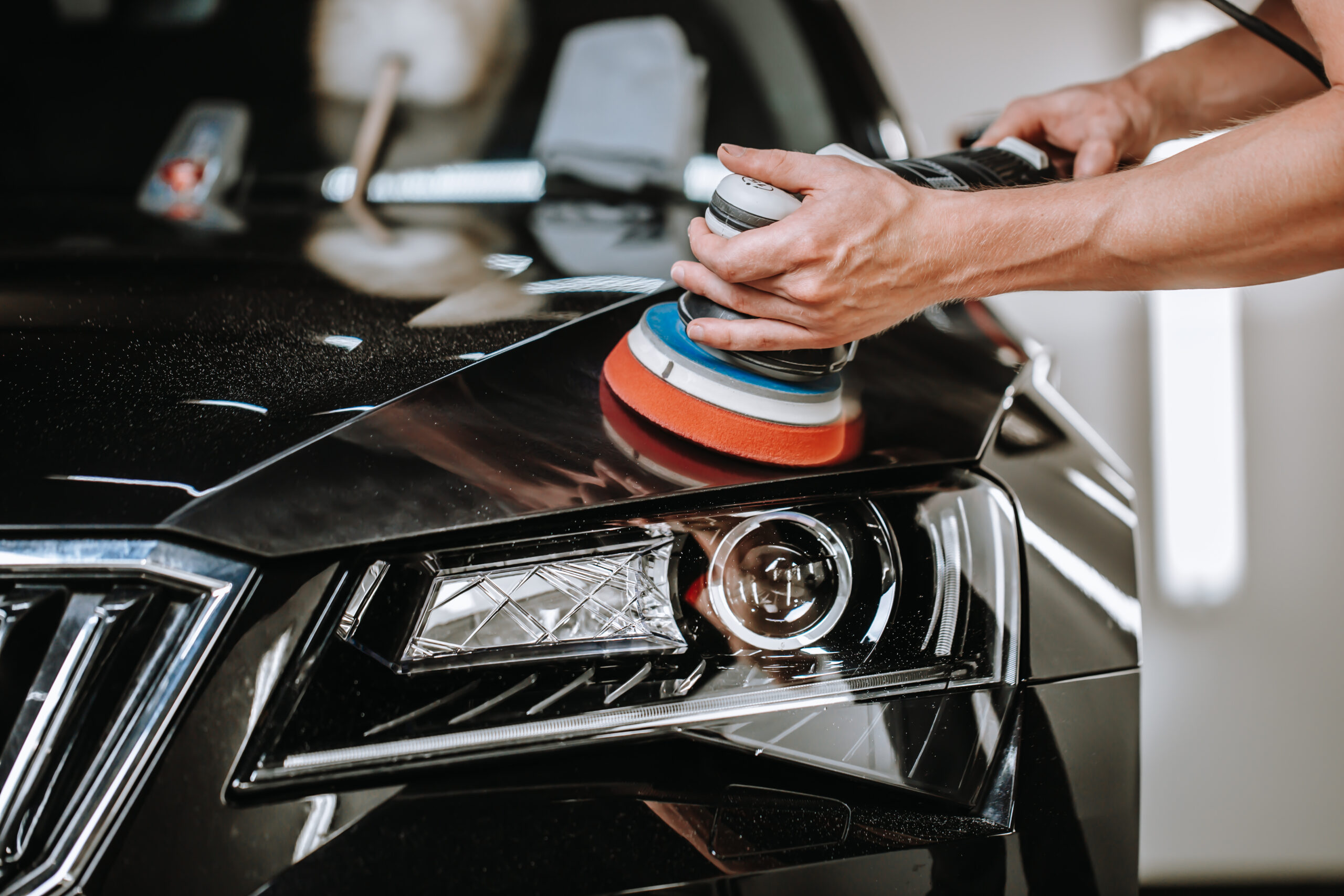 professional process of detailing a car in car studio, hands wit